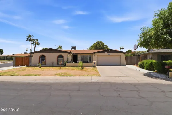 a front view of a house with a yard and a garage