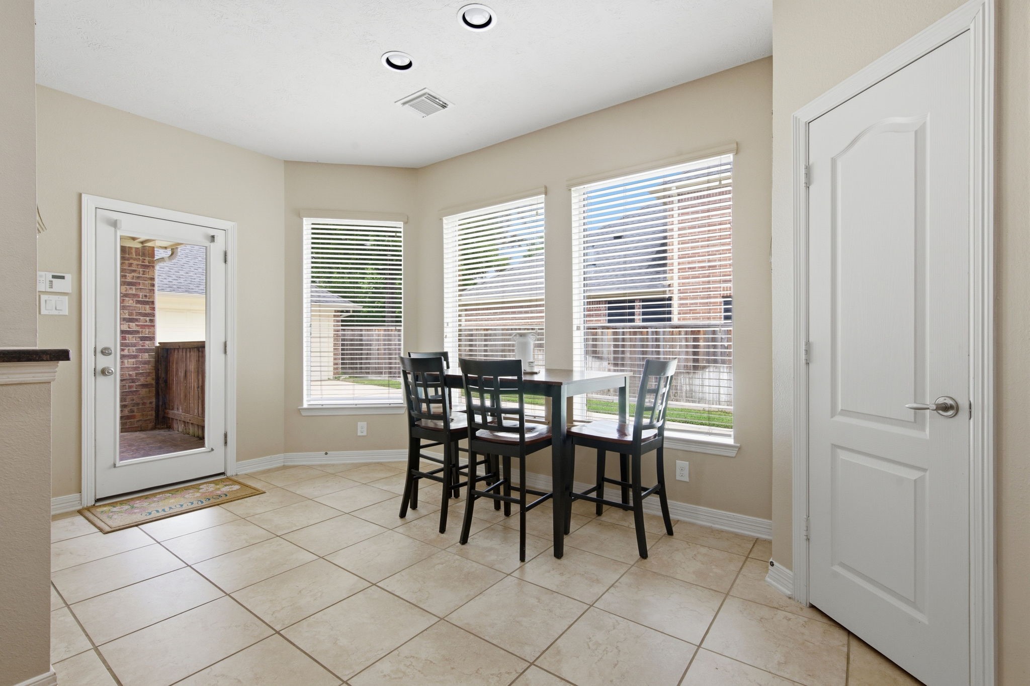 9722 Blue Cruls Way Spring, TX 77379 - Photo 21 of 45 Door to backyard has covered area leading to garage. No need for an umbrella coming from the garage. Views to the extended driveway.