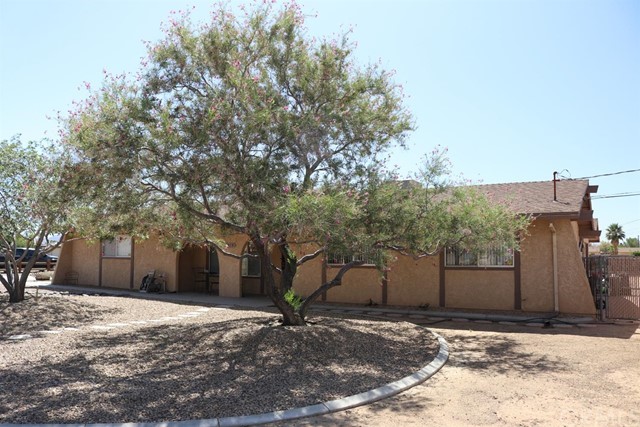 20979 Zuni Road Apple Valley, CA 92307 - Photo 1 of 1 a view of a house with a yard and garage
