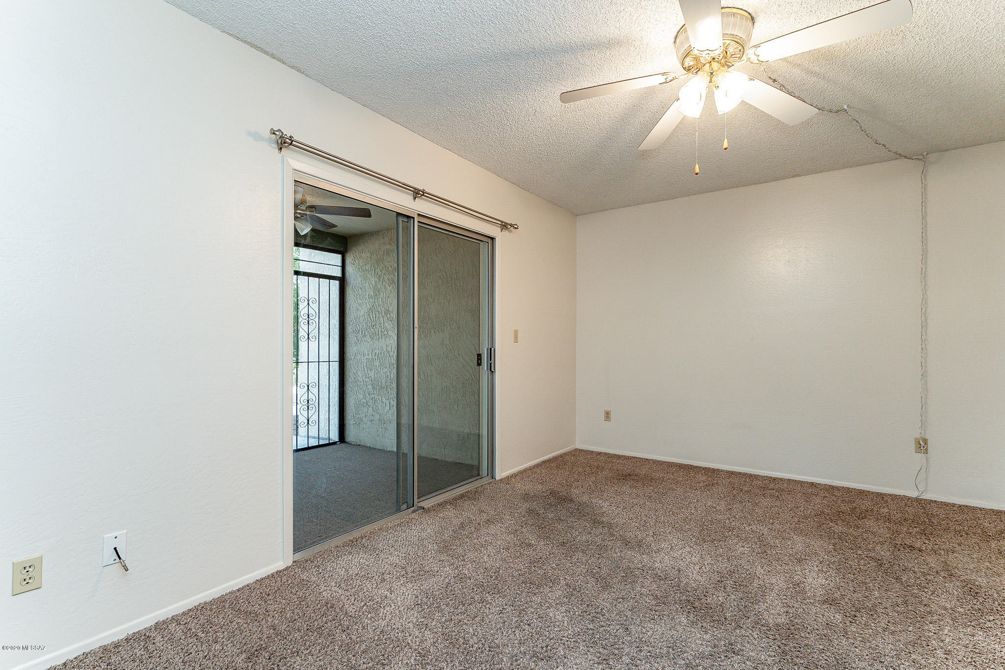 3750 North Country Club Road, Unit 7 Tucson, AZ 85716 - Photo 12 of 26 an empty room with a chandelier fan and closet area