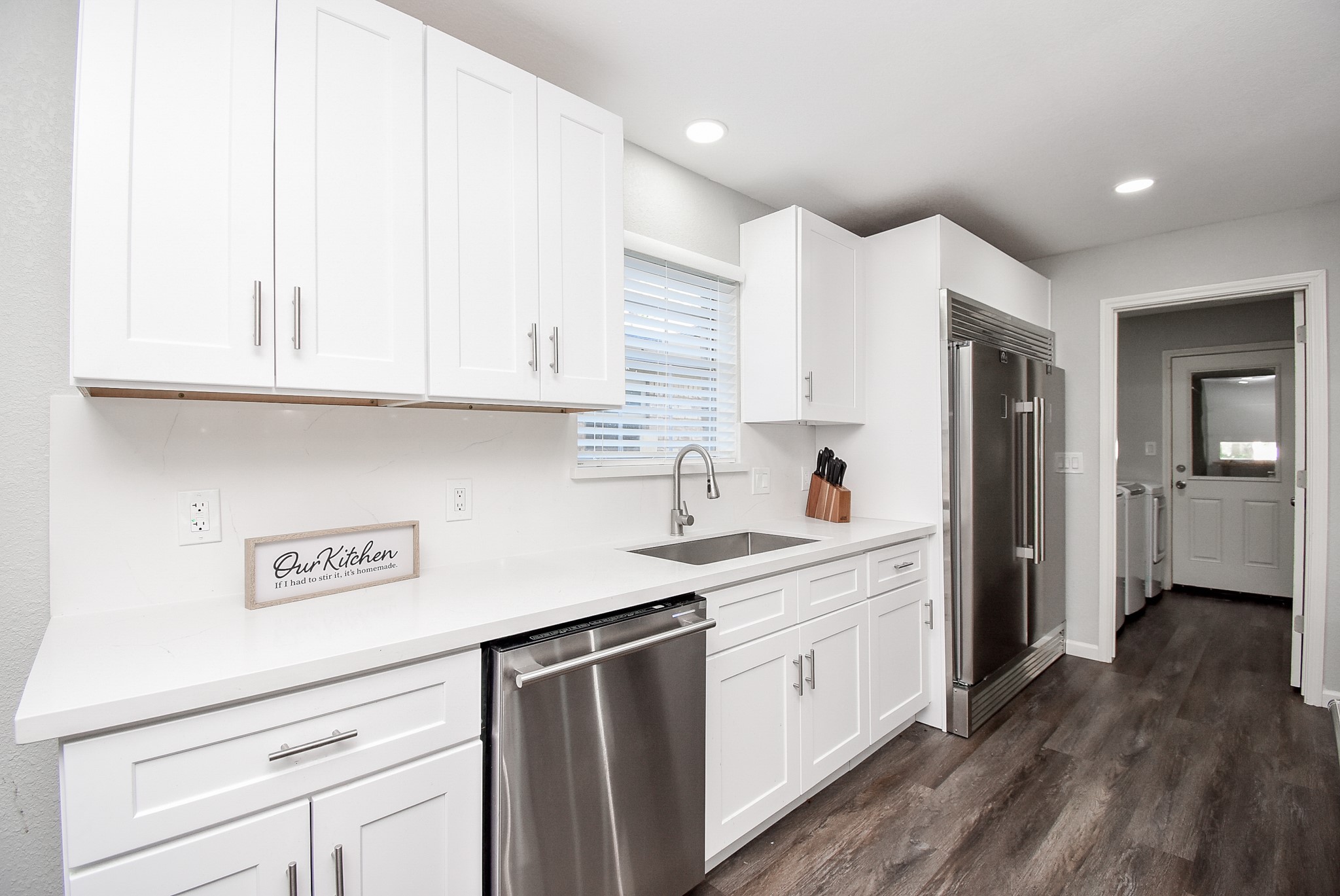 12435 Shepherds Ridge Drive Houston, TX 77077 - Photo 21 of 47 a kitchen with stainless steel appliances granite countertop a white stove top oven and white cabinets