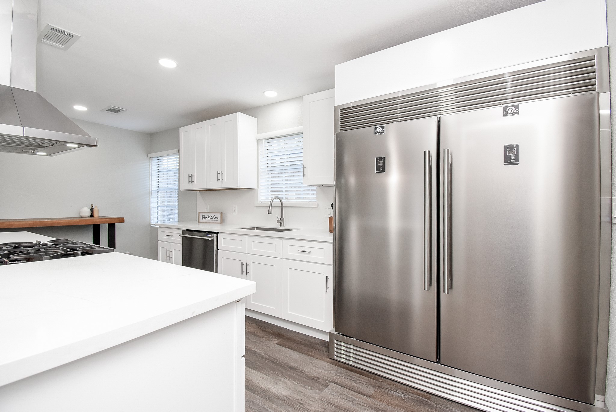 12435 Shepherds Ridge Drive Houston, TX 77077 - Photo 22 of 47 a kitchen with a refrigerator a sink and cabinets