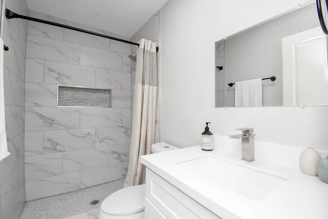 a bed sitting in a room next to a lamp