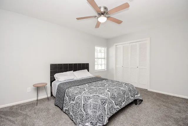 a bedroom with a bed and window