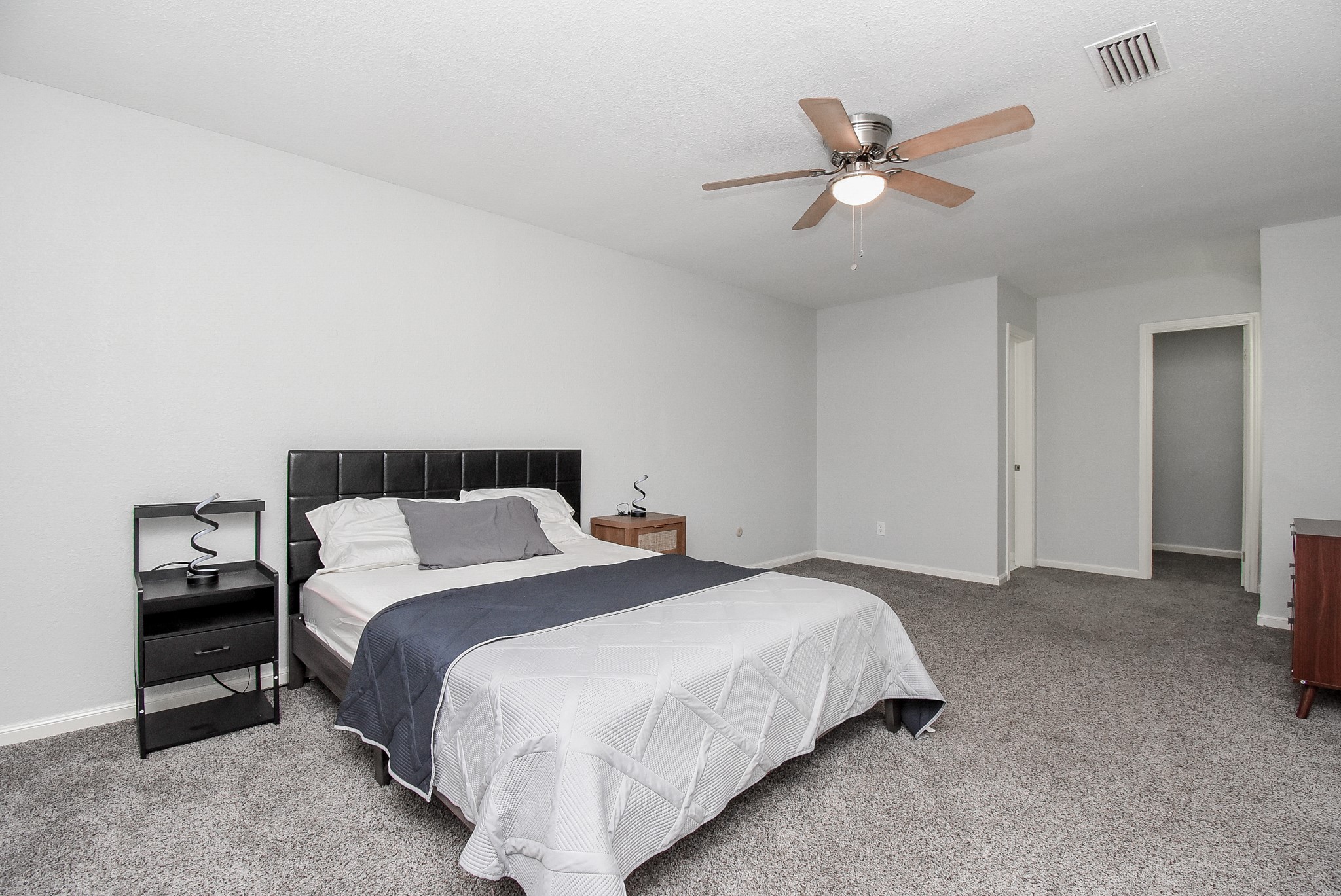 12435 Shepherds Ridge Drive Houston, TX 77077 - Photo 36 of 47 a bedroom with a bed and a ceiling fan