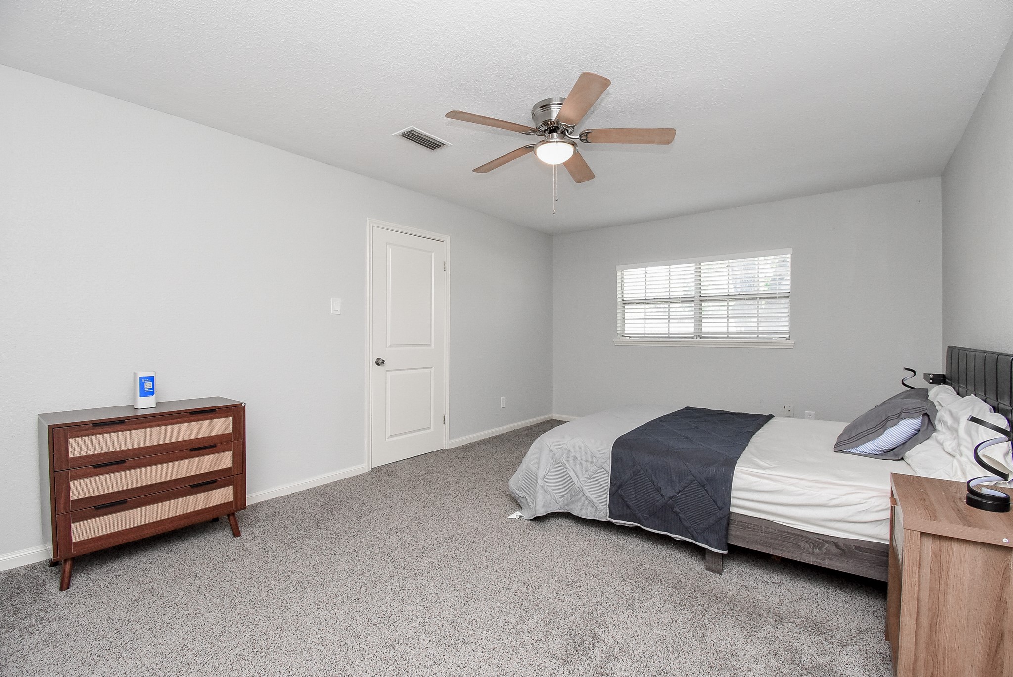 12435 Shepherds Ridge Drive Houston, TX 77077 - Photo 37 of 47 a bedroom with a bed and a chandelier