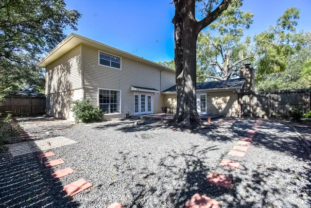 a view of a house with a tree in the yard