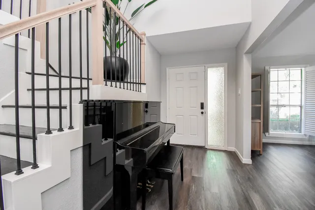 a view of entryway and hall with wooden floor