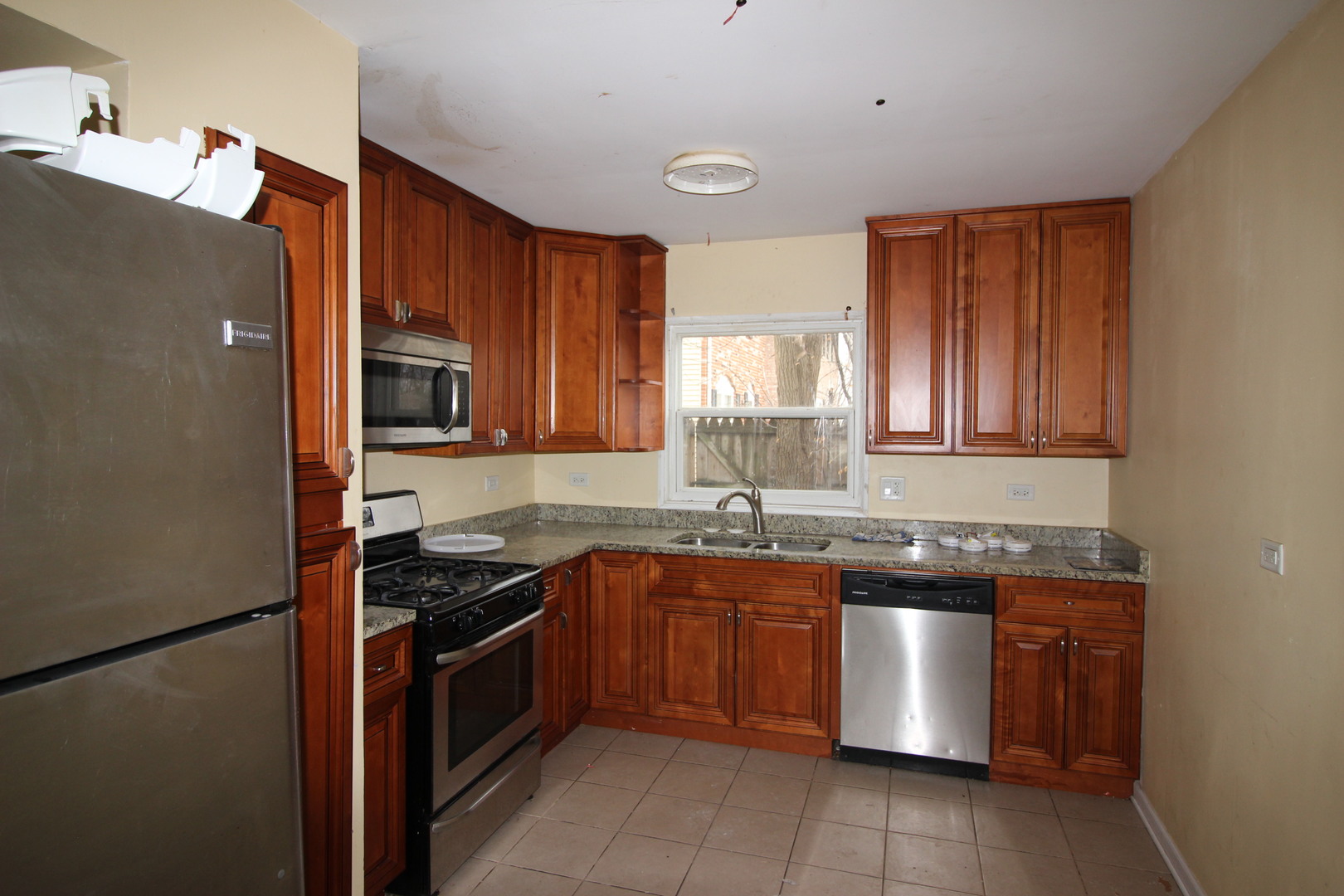 1723 McKool Avenue Streamwood, IL 60107 - Photo 2 of 11 a kitchen with stainless steel appliances granite countertop a sink stove and refrigerator