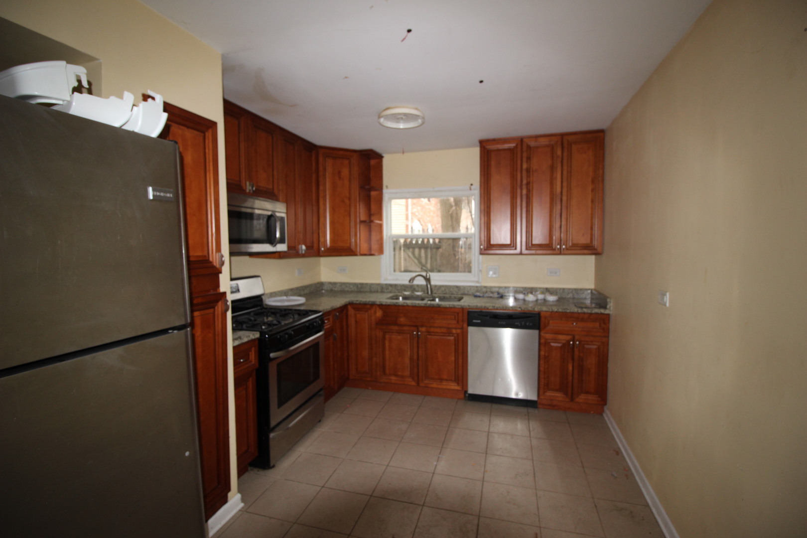 1723 McKool Avenue Streamwood, IL 60107 - Photo 3 of 11 a kitchen with stainless steel appliances granite countertop a refrigerator a stove a sink and a microwave
