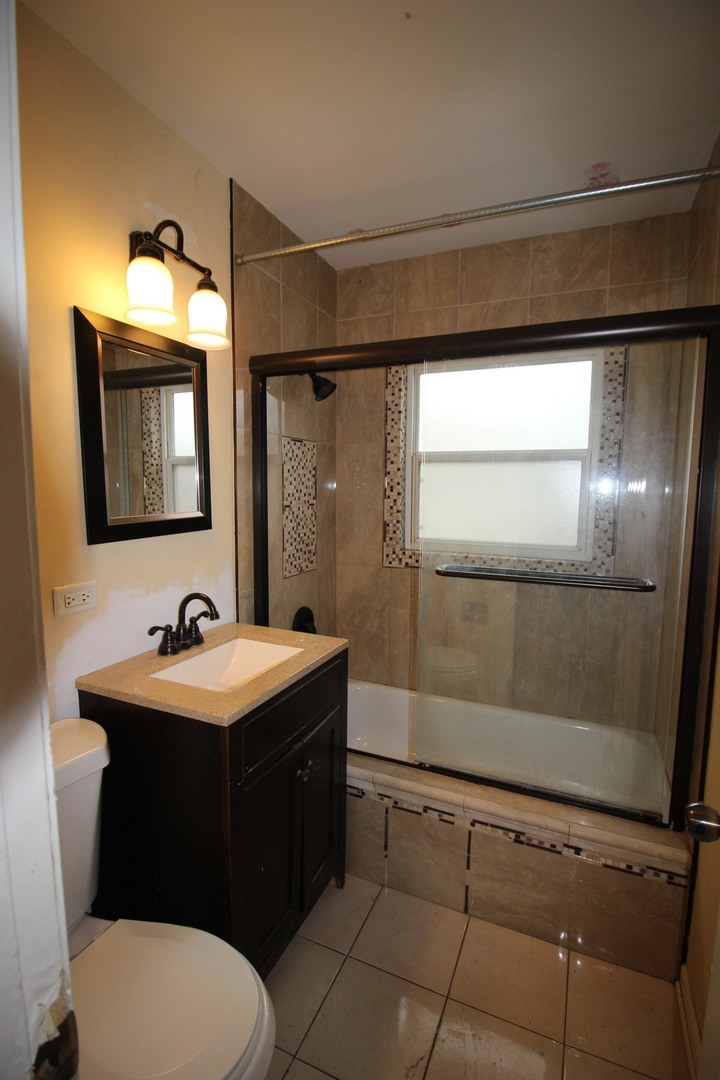 1723 McKool Avenue Streamwood, IL 60107 - Photo 9 of 11 a bathroom with a sink a toilet and mirror