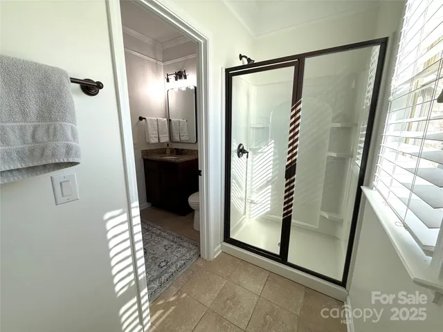 a living room with furniture and large windows