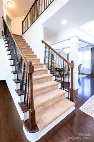 a bedroom with a large bed and a chandelier