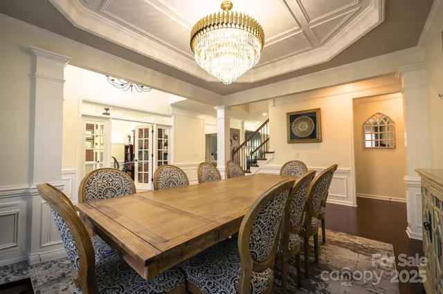 a bedroom with a bed and a lamp on dresser