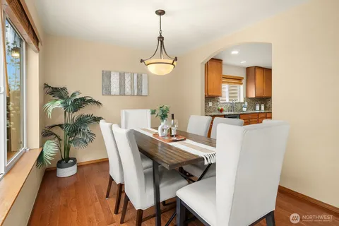 a dining room with furniture and wooden floor