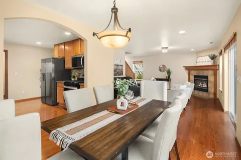 a kitchen with granite countertop cabinets stainless steel appliances a sink and a large window