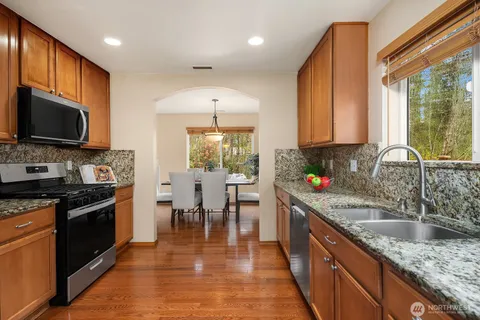 a kitchen with stainless steel appliances a stove a sink and a microwave