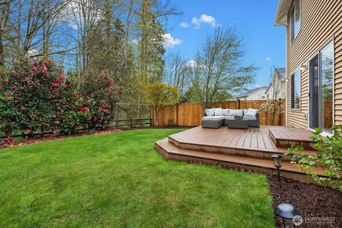 a view of house with backyard and furniture