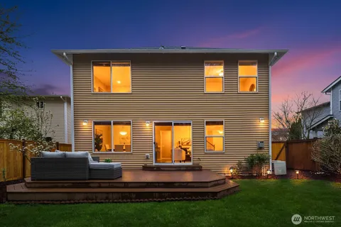 a view of a backyard with sitting area