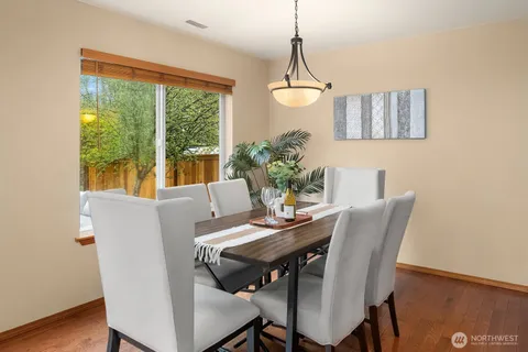 a view of a dining room with furniture window and wooden floor