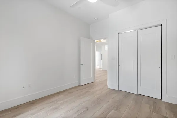 a view of an empty room and wooden floor