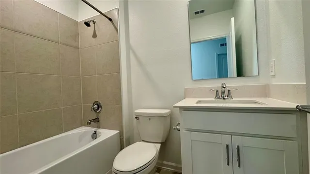 a bathroom with a sink toilet vanity and shower