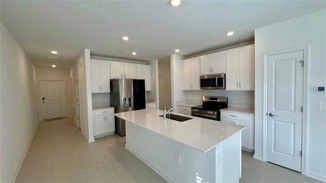 a kitchen with stainless steel appliances a refrigerator stove microwave and cabinets