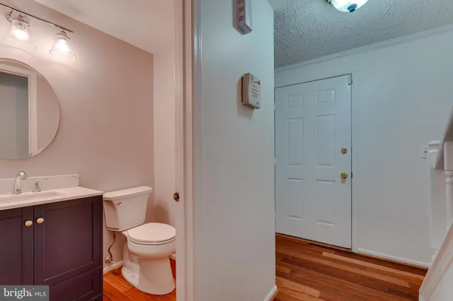 a bathroom with a toilet a sink and mirror