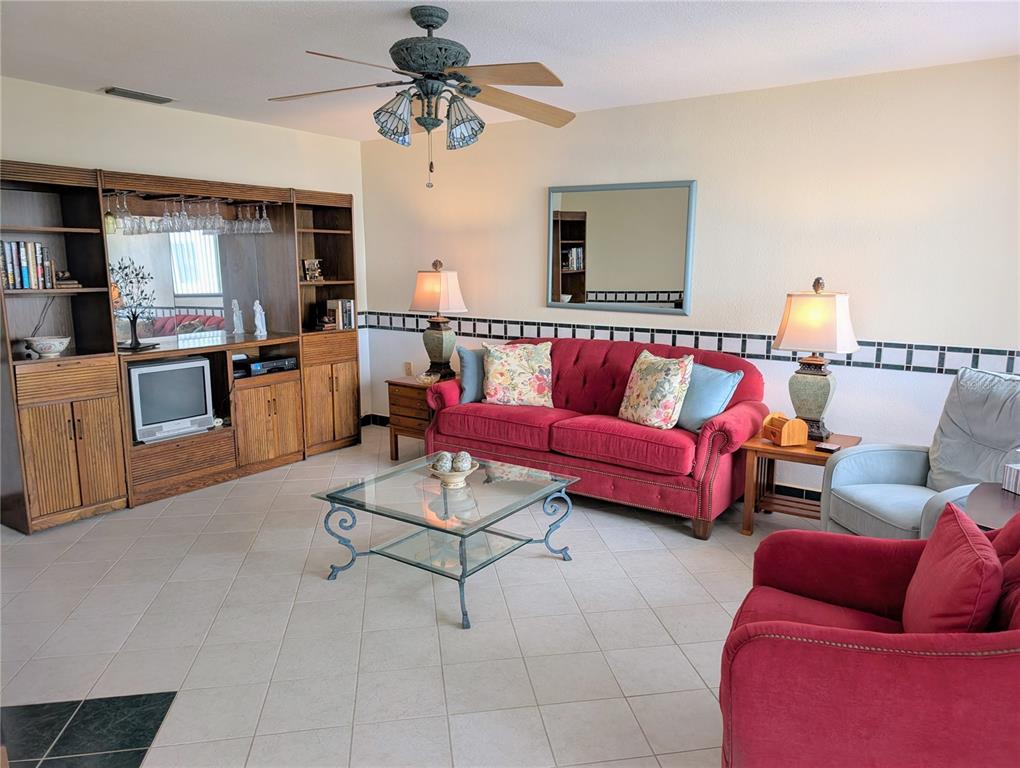 8055 112th Street North, Unit 403 Seminole, FL 33772 - Photo 11 of 37 a living room with furniture and kitchen view