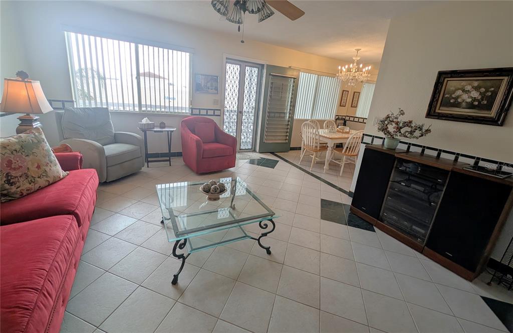 8055 112th Street North, Unit 403 Seminole, FL 33772 - Photo 12 of 37 a living room with furniture and a flat screen tv