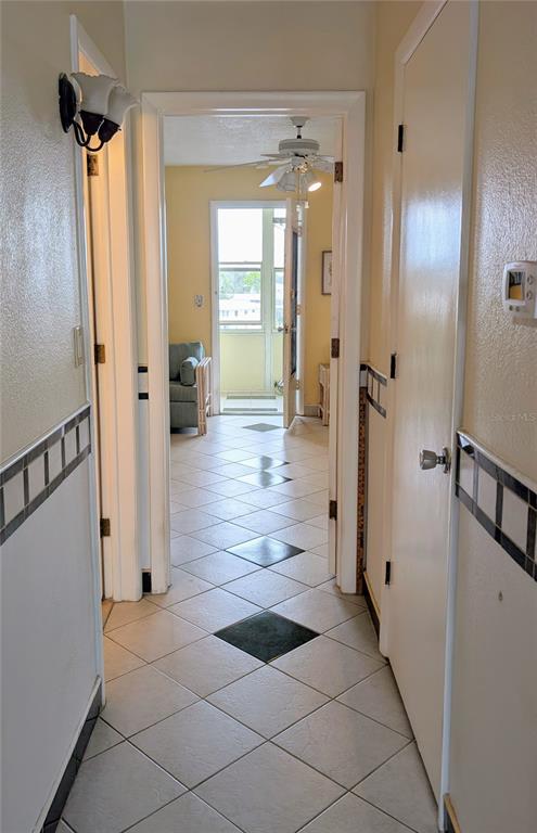 8055 112th Street North, Unit 403 Seminole, FL 33772 - Photo 13 of 37 a view of a hallway with wooden floor and staircase