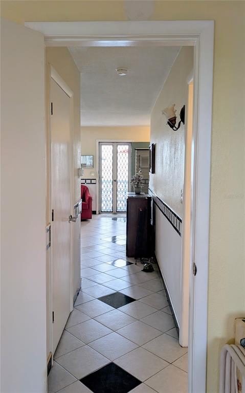 8055 112th Street North, Unit 403 Seminole, FL 33772 - Photo 15 of 37 a kitchen with stainless steel appliances kitchen island granite countertop a refrigerator and a sink
