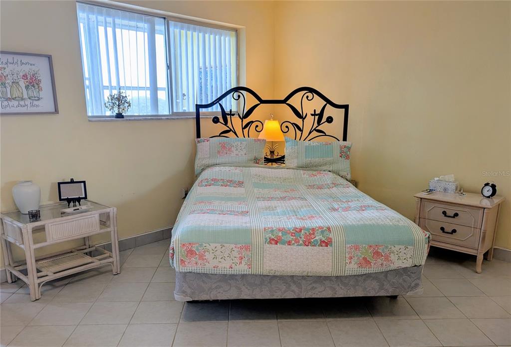 8055 112th Street North, Unit 403 Seminole, FL 33772 - Photo 17 of 37 a bedroom with a bed and a window