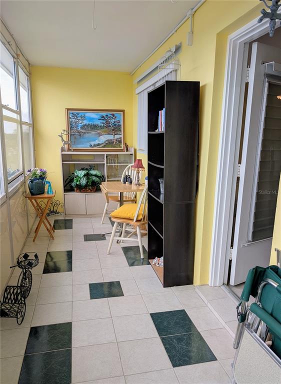 8055 112th Street North, Unit 403 Seminole, FL 33772 - Photo 24 of 37 a living room with furniture and a flat screen tv