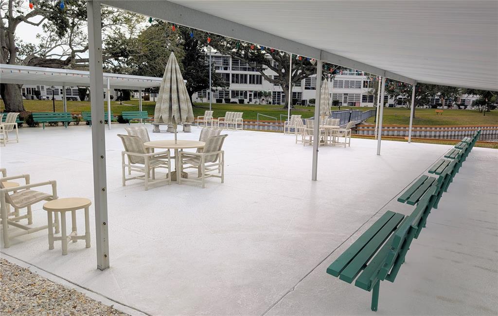 8055 112th Street North, Unit 403 Seminole, FL 33772 - Photo 33 of 37 a view of a patio with dining table and chairs