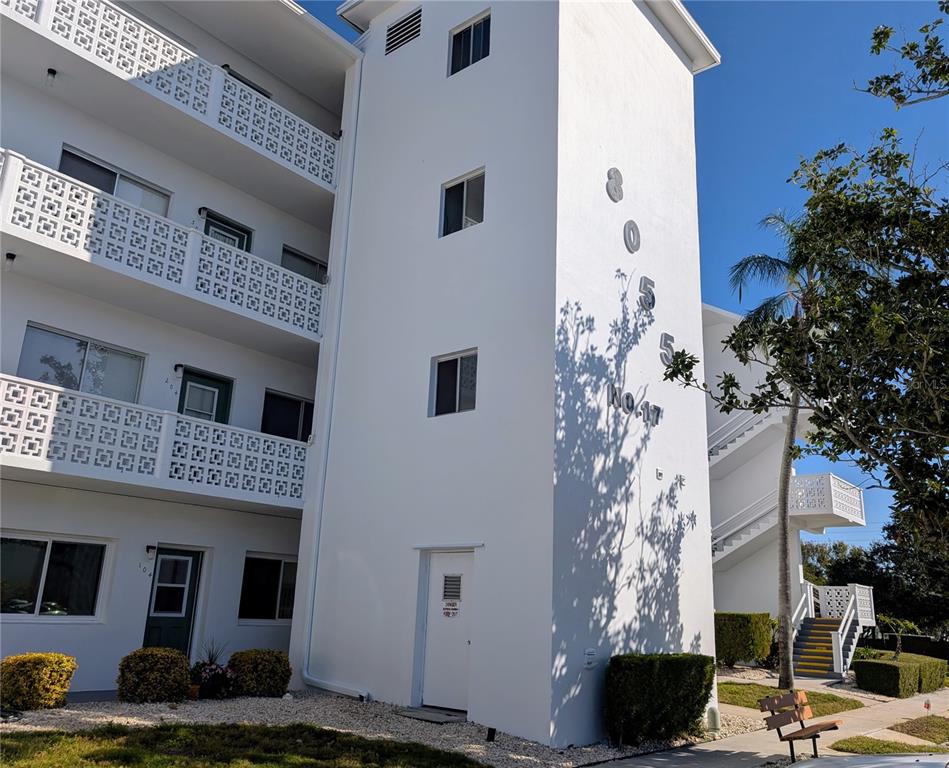 8055 112th Street North, Unit 403 Seminole, FL 33772 - Photo 36 of 37 a front view of a house with a yard