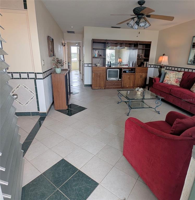 8055 112th Street North, Unit 403 Seminole, FL 33772 - Photo 5 of 37 a living room with furniture and a flat screen tv
