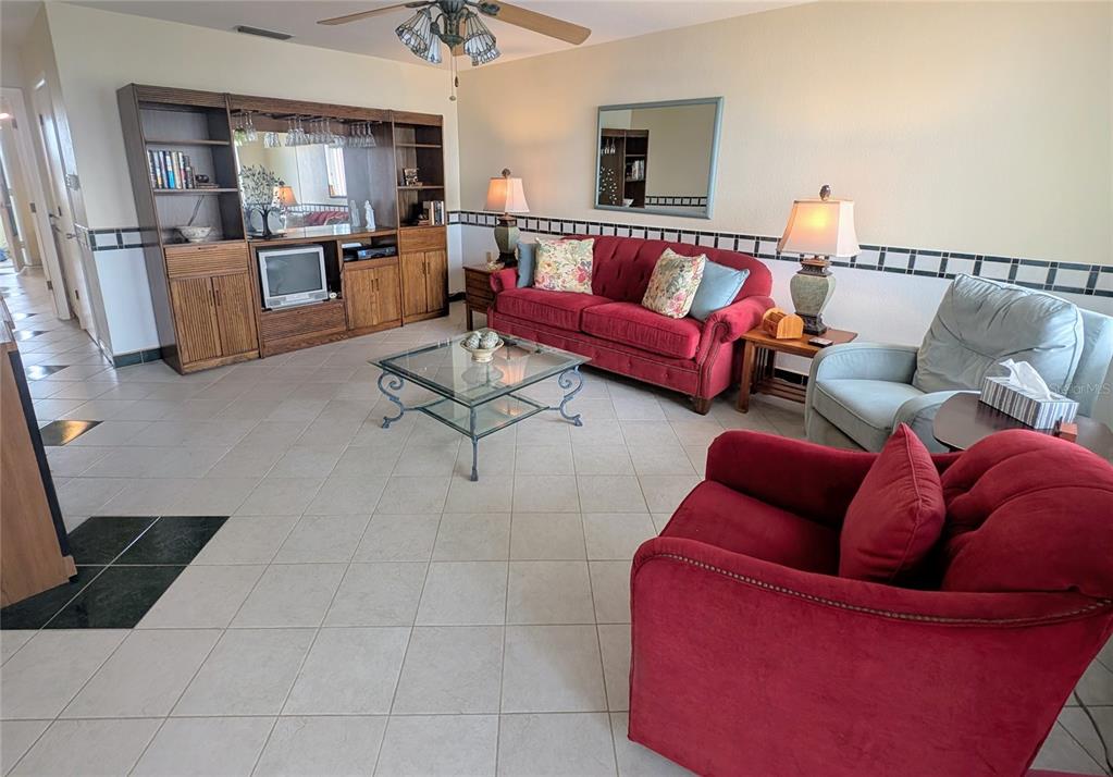 8055 112th Street North, Unit 403 Seminole, FL 33772 - Photo 10 of 37 a living room with furniture and a wooden floor