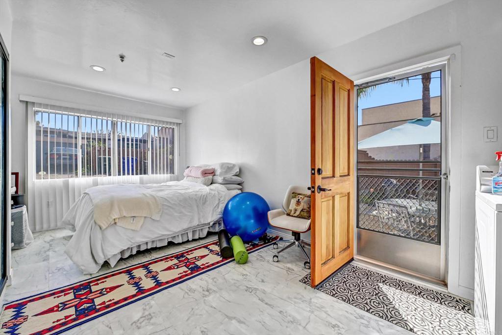 223 3rd Street Encinitas, CA 92024 - Photo 35 of 68 a bed sitting in a bedroom next to a window