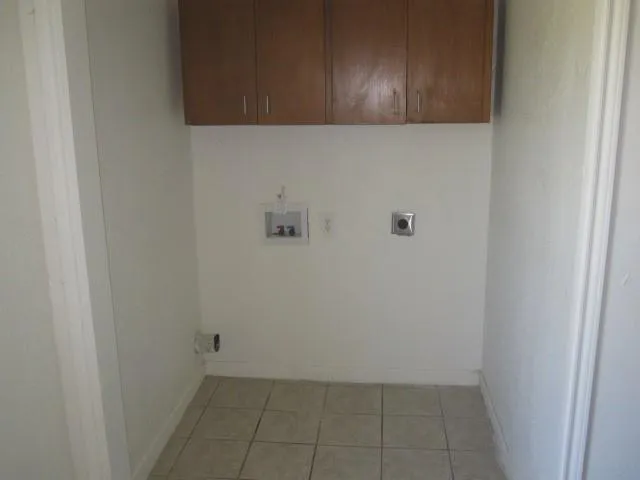 a view of staircase with white walls and white door