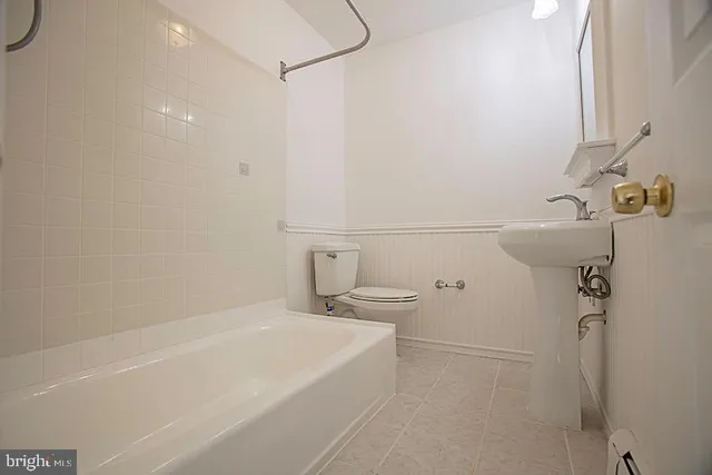 a bathroom with a white bath tub and a shower