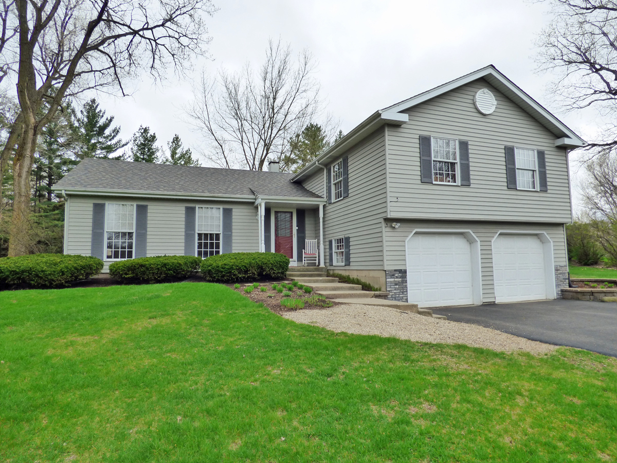 41W121 Whitney Road St. Charles, IL 60175 - Photo 1 of 35 a front view of a house with a garden and yard