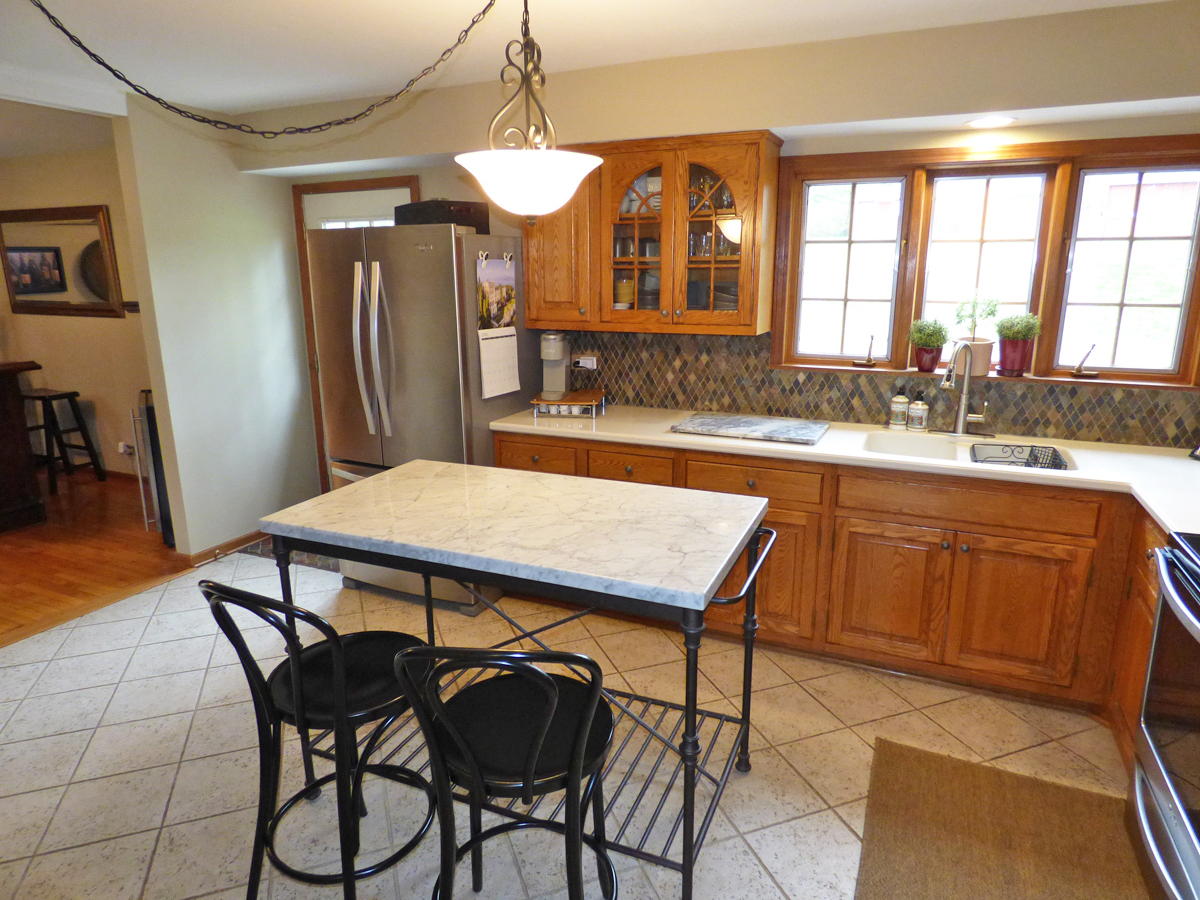 41W121 Whitney Road St. Charles, IL 60175 - Photo 11 of 35 a dining table chair with granite countertop a refrigerator a stove a kitchen island and chairs