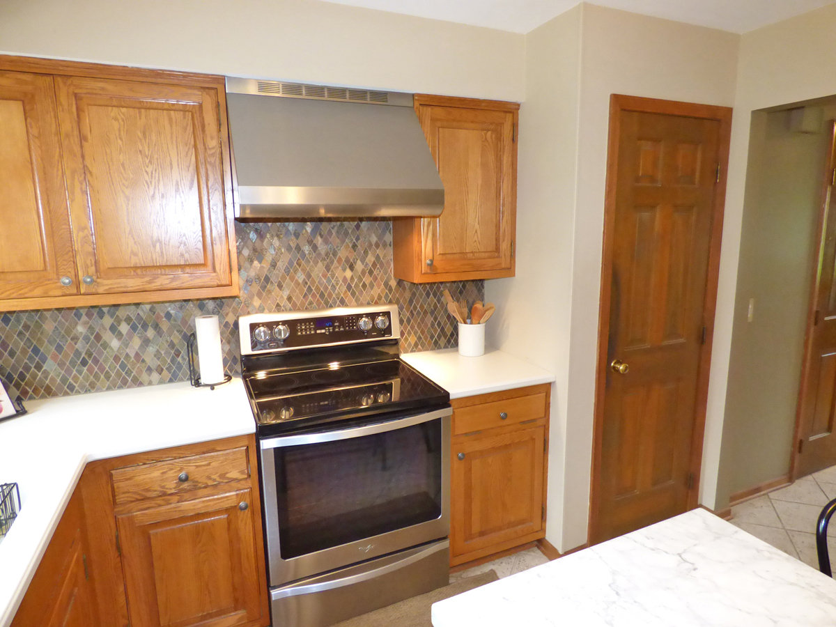 41W121 Whitney Road St. Charles, IL 60175 - Photo 13 of 35 a kitchen with a stove and a microwave