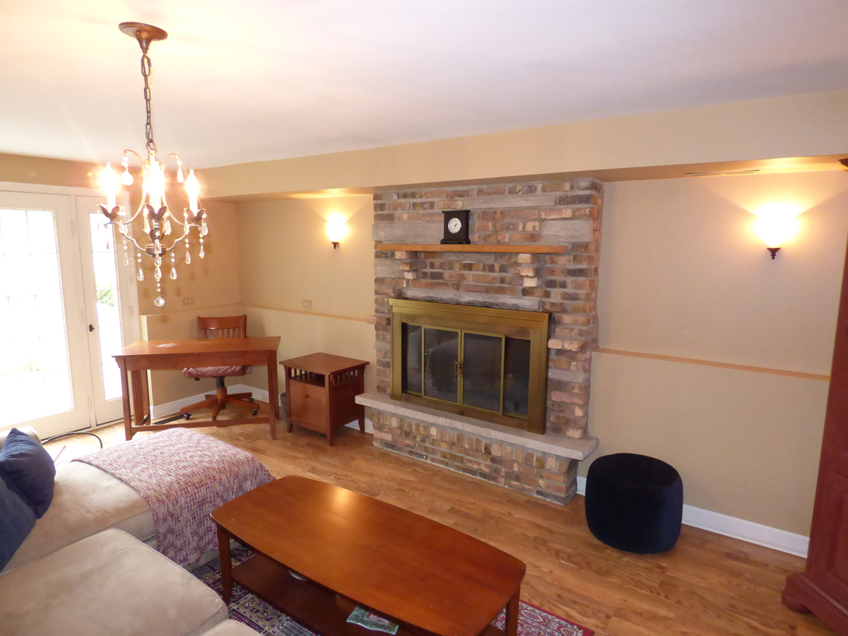 41W121 Whitney Road St. Charles, IL 60175 - Photo 23 of 35 a living room with furniture and a fireplace