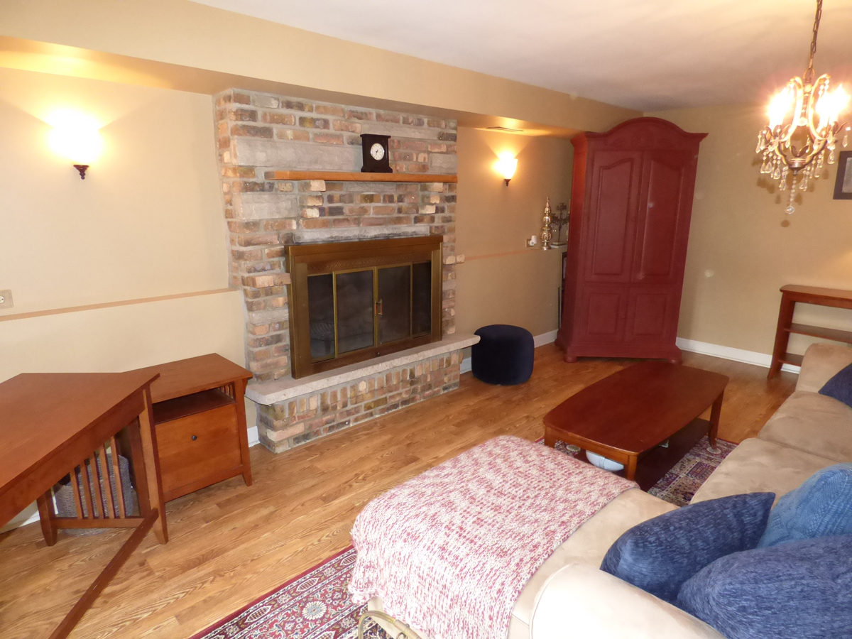 41W121 Whitney Road St. Charles, IL 60175 - Photo 24 of 35 a bedroom with furniture and a fireplace