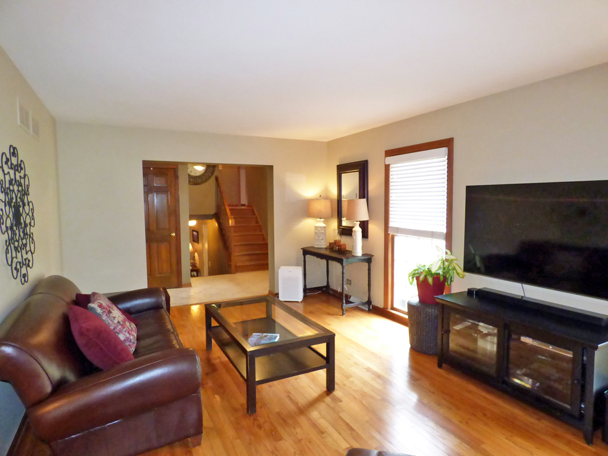 41W121 Whitney Road St. Charles, IL 60175 - Photo 8 of 35 a living room with furniture and a flat screen tv