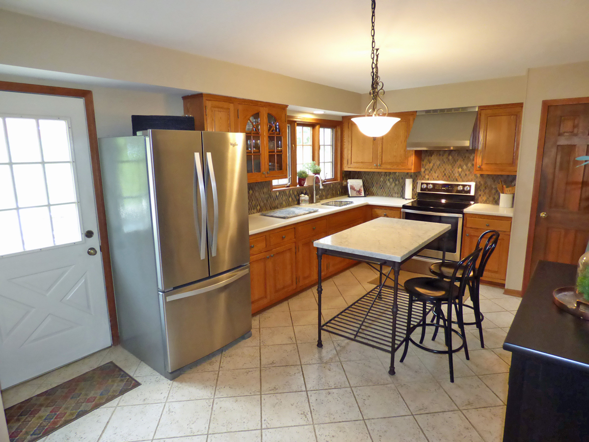 41W121 Whitney Road St. Charles, IL 60175 - Photo 10 of 35 a kitchen with stainless steel appliances granite countertop a refrigerator and a stove top oven