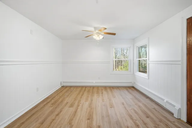 wooden floor in an empty room with a window