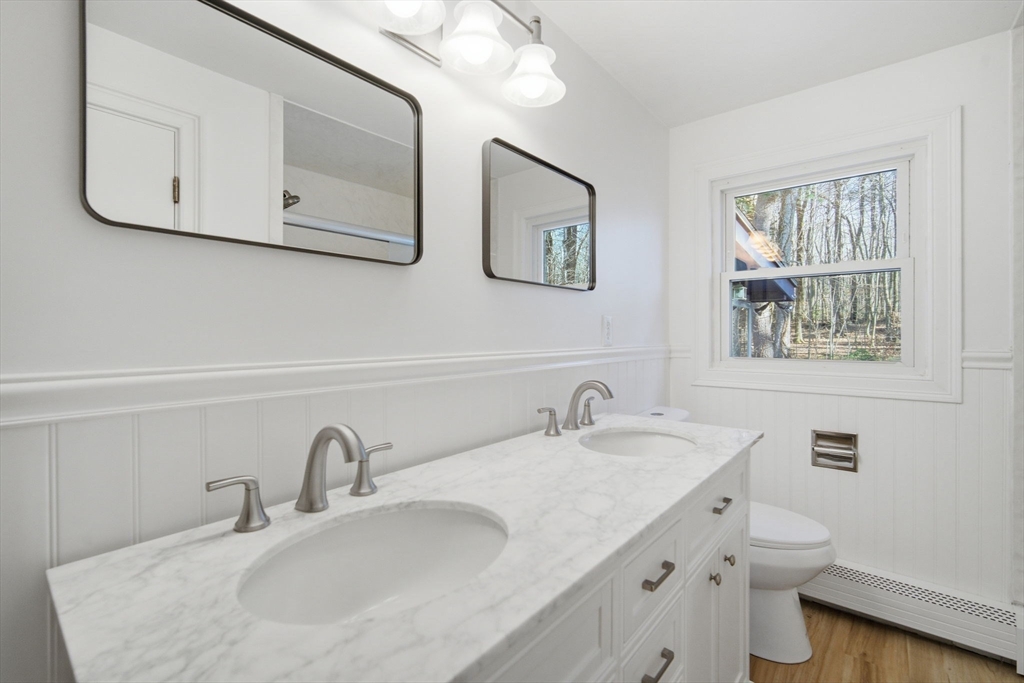 7 Fuller Road Sutton, MA 01590 - Photo 15 of 29 a bathroom with double vanity sink a toilet and a mirror